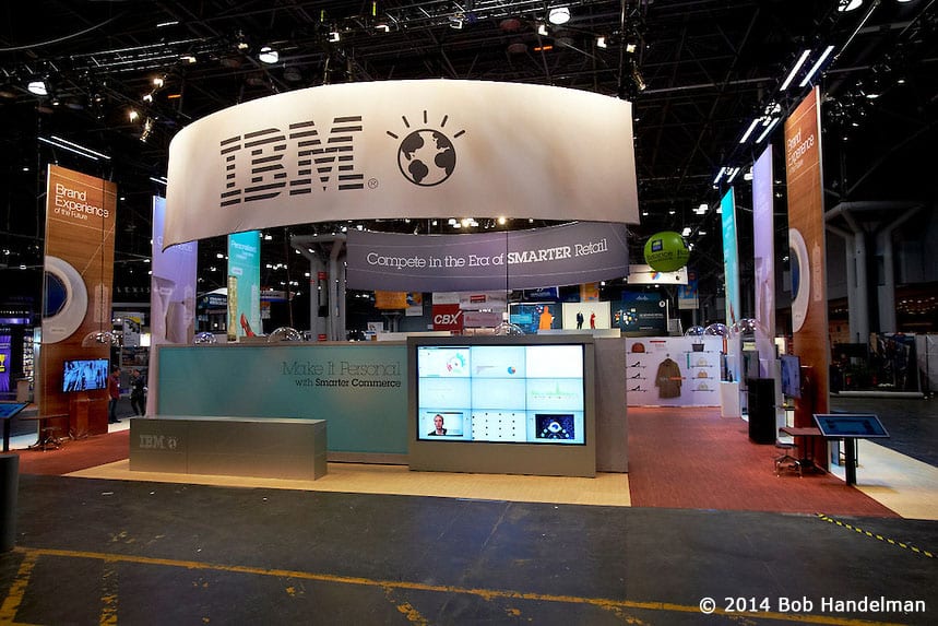 The finished IBM booth the night before NRF 2014 opened, with its curved IBM sign lit overhead
