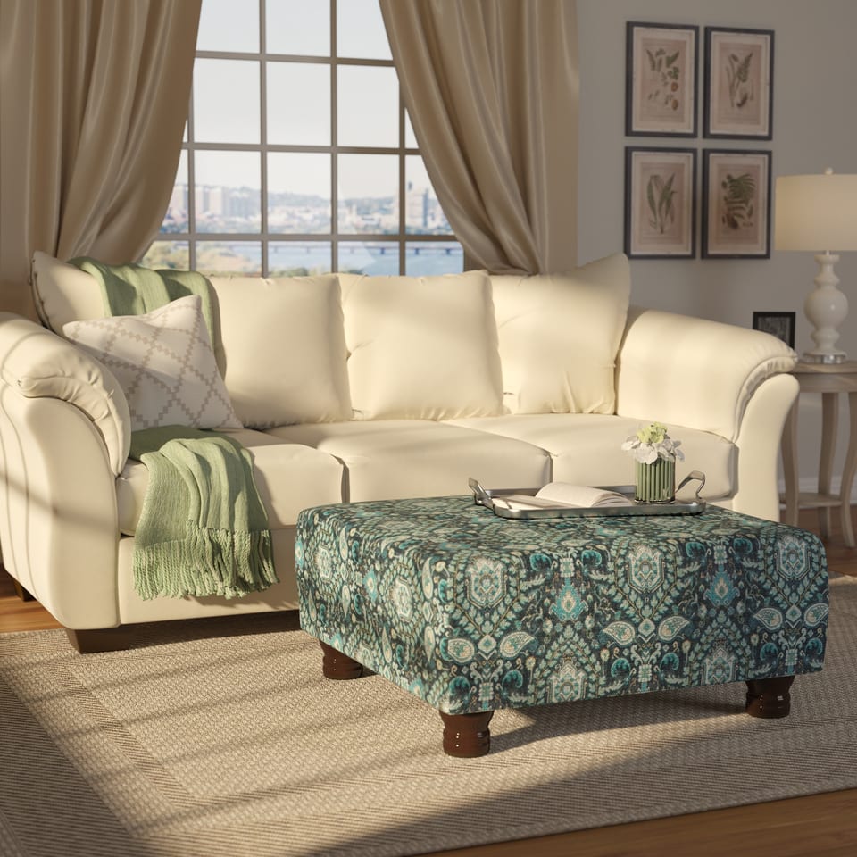 3D rendering of a living room with a cream sofa and patterned ottoman
