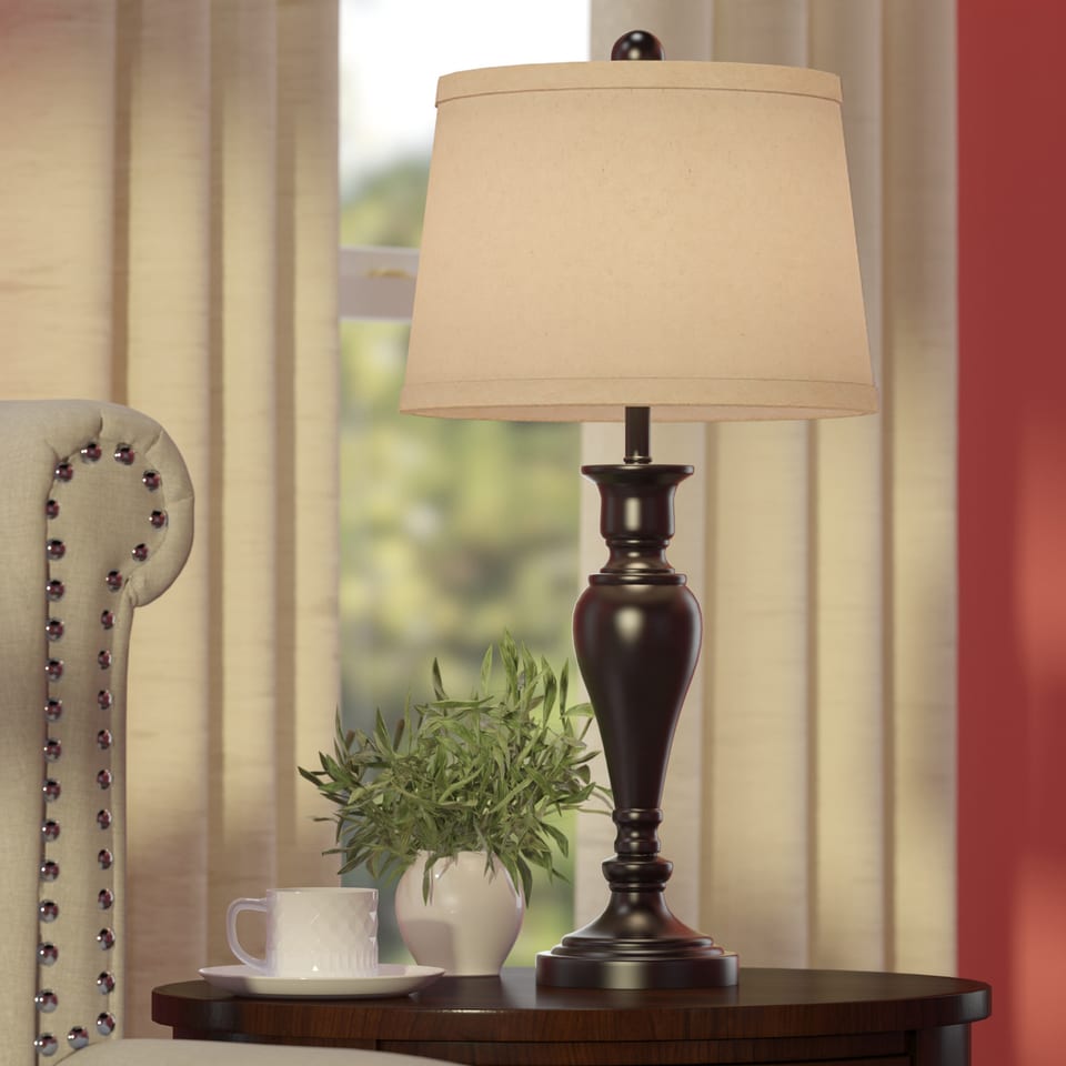 3D rendering of a table lamp on a side table beside a tufted chair